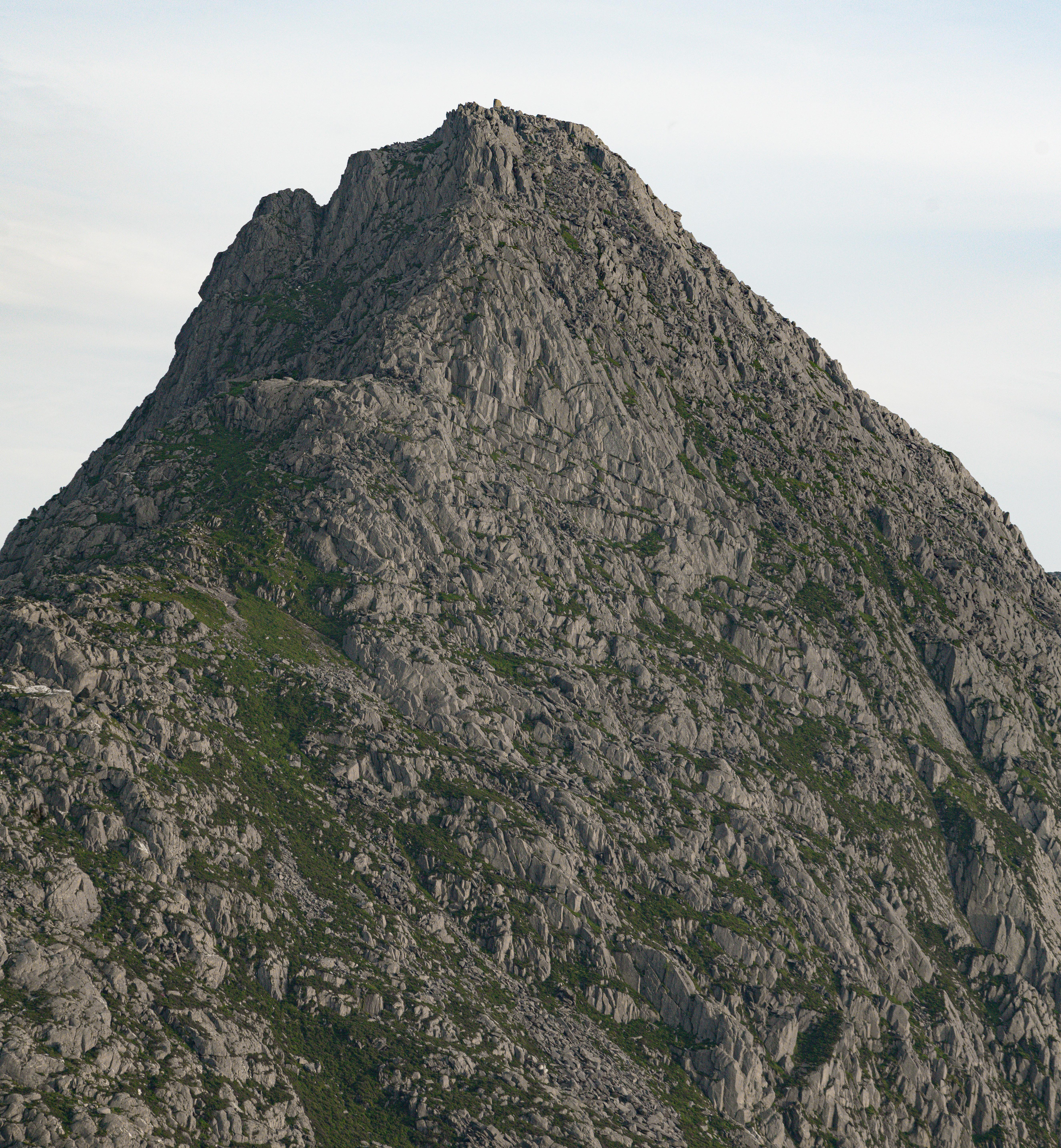 There is a man climbing the mountain hidden in this photo, but he is very difficult to find