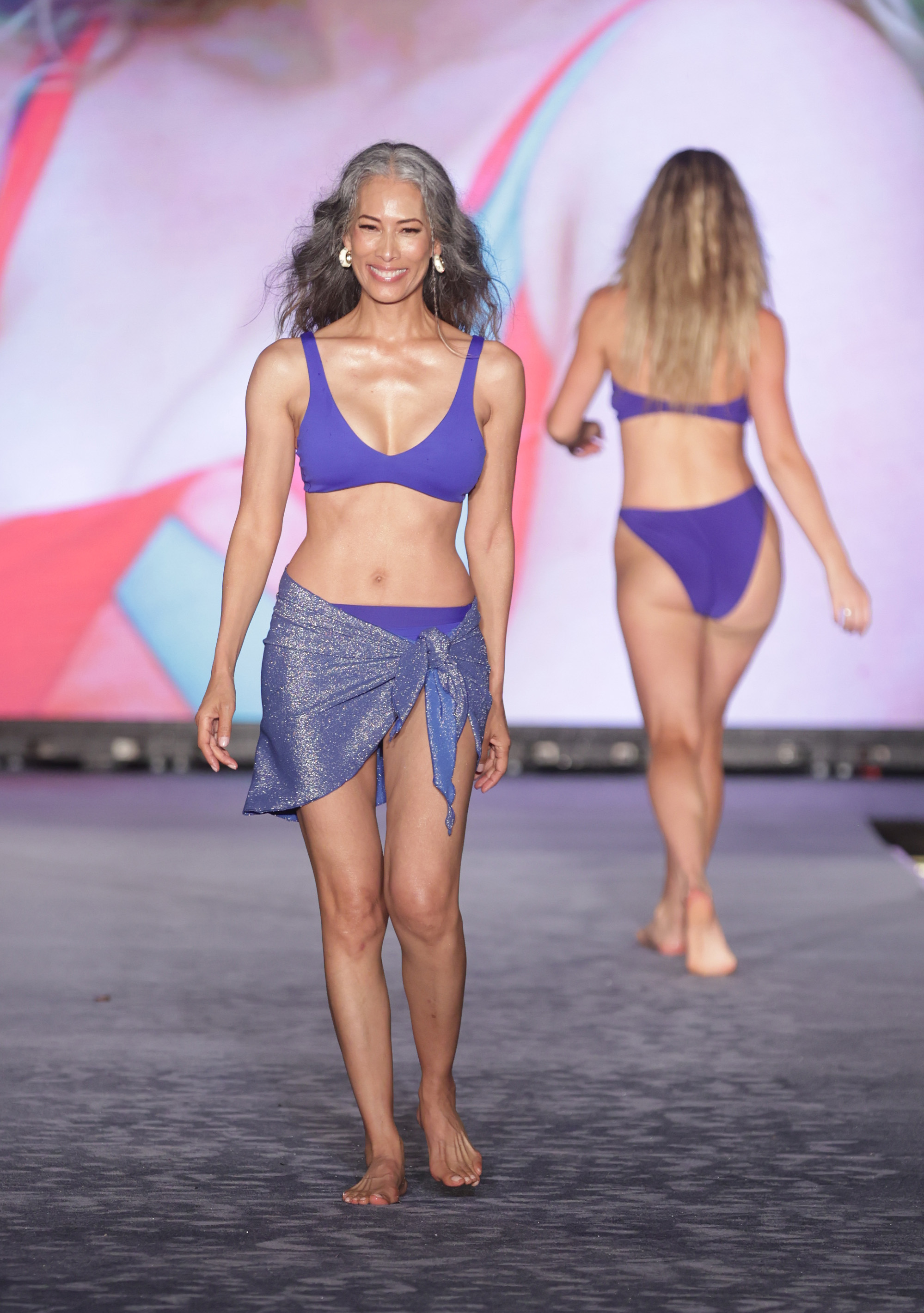 Nina Cash proves age is just a number as she struts down the runway in a bikini