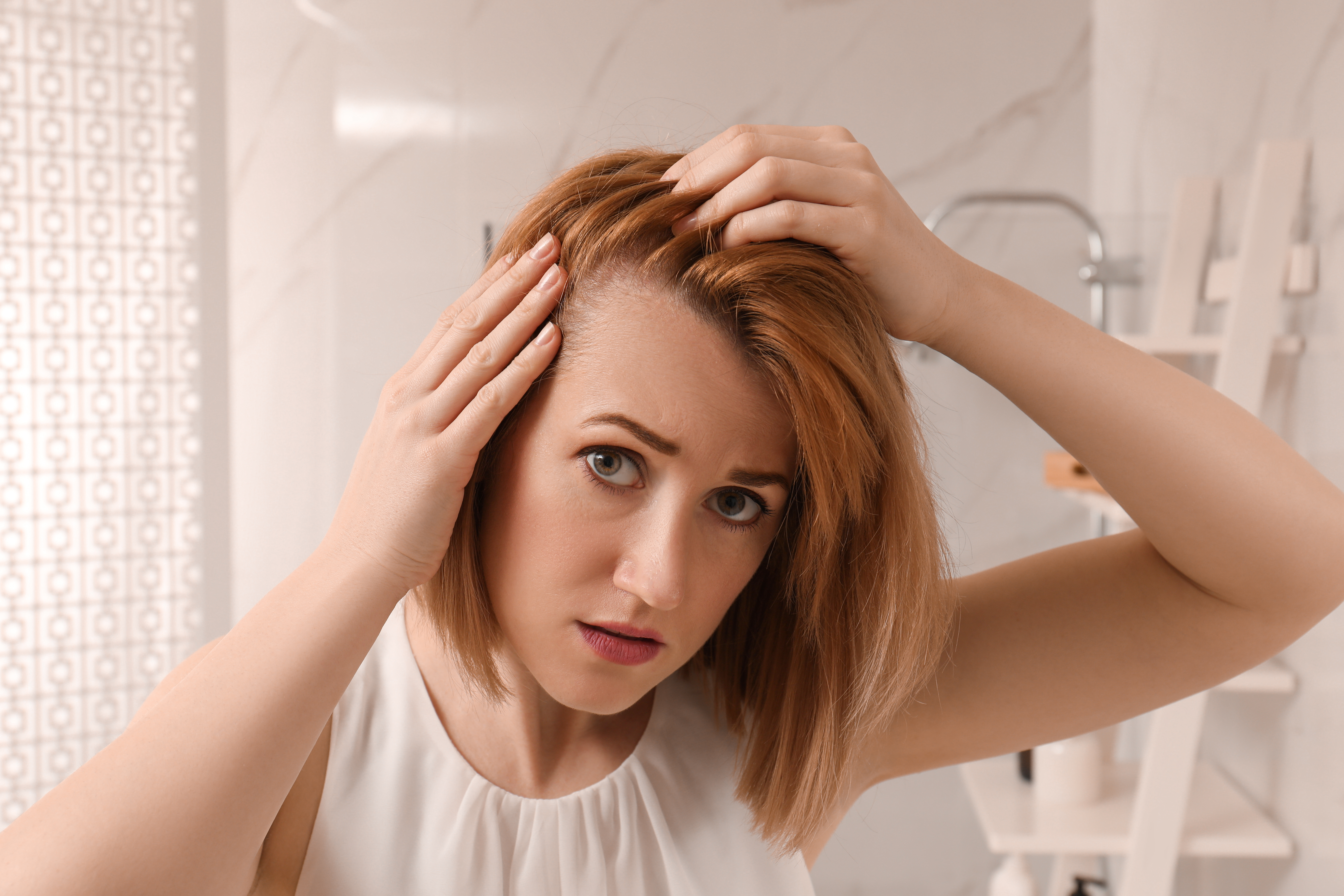 A balding woman shared her favorite hair growth product (stock photo)