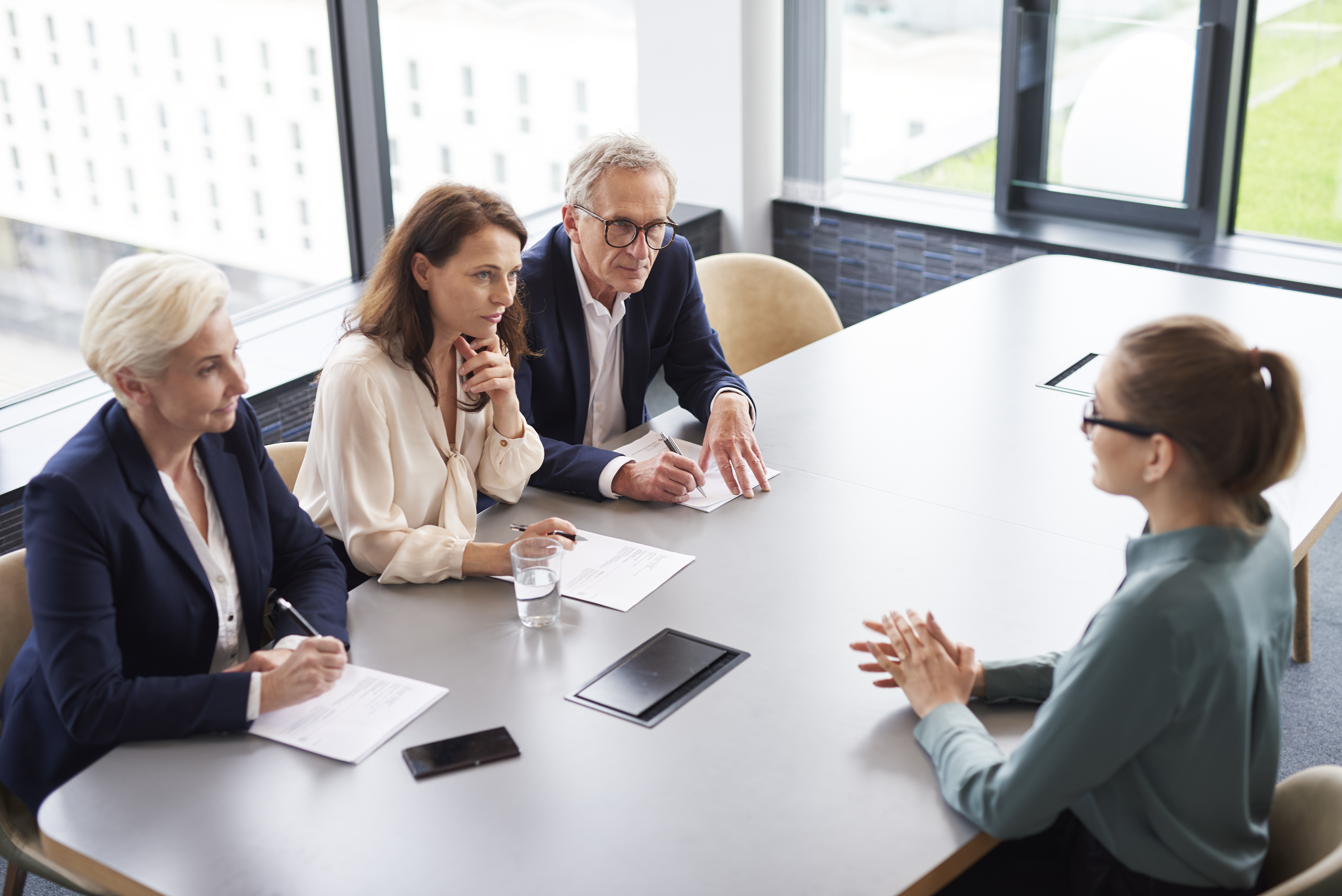 Woman at job interview and three elegant members of management