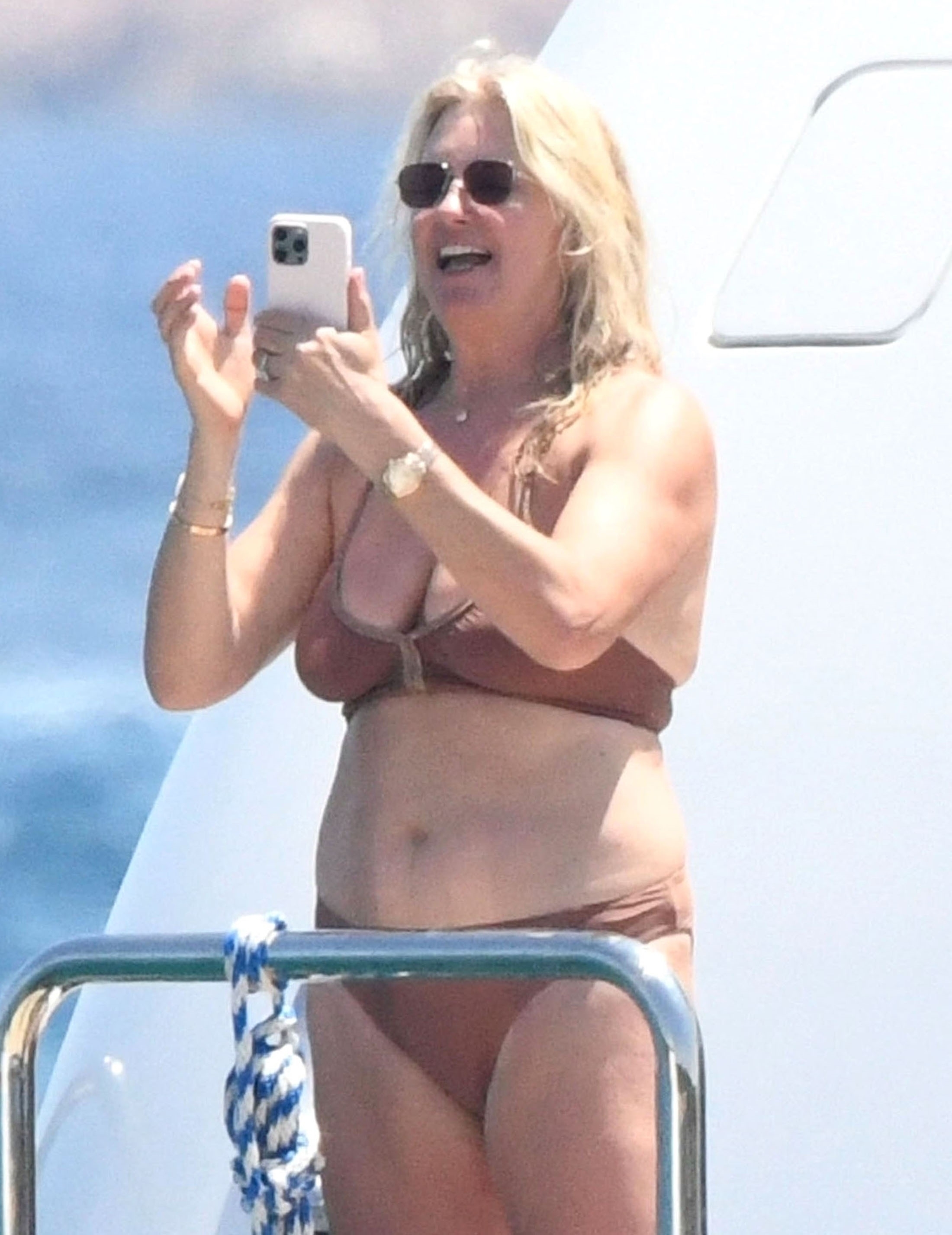 Penny Lancaster, 53, was photographed on holiday showing off a series of tiny bikinis