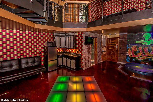 Pictured: The amazing hotel suite with a nightclub theme, featuring a hot tub, disco ball and a dance cage with a STRIPPER POLE