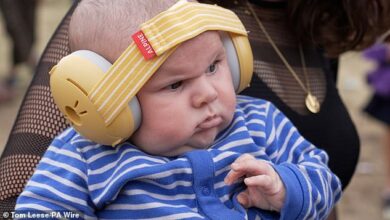 Baby’s first rave…and he’s NOT impressed!: Little 10-week-old Finlay wins over the Glastonbury crowd and looks VERY grumpy at Annie Mac’s set