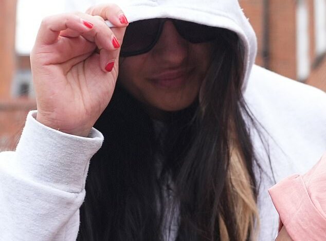 Wandsworth female prison officer Linda De Sousa Abreu, 30, accused of having sex with prisoner in X-rated video hides her face as she leaves court – after police arrested her at Heathrow Airport