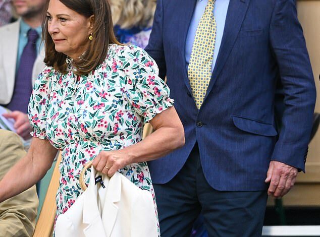 Carole Middleton has a big smile on her face as she chats to Seb Coe in the Royal Box at Wimbledon, while enjoying a day out with her husband Michael