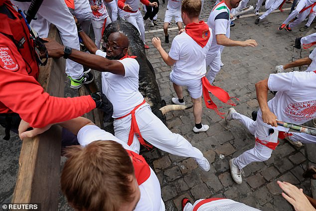 Pamplona bull run is thrown around and trampled as more thrill seekers are injured under the hooves of rampaging animals in a Spanish town