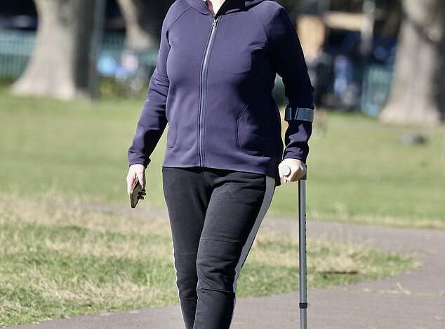 Samantha Armytage puts on a brave face as she gets back on her feet with the help of a crutch, her first public appearance since her hip replacement