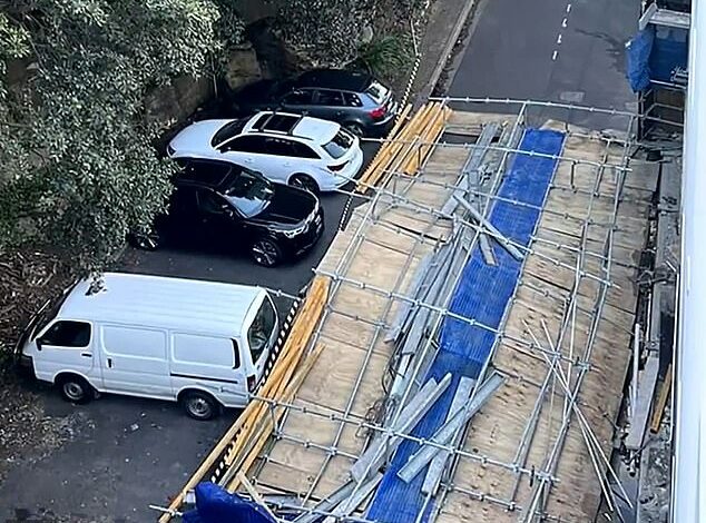 Woman miraculously escapes unharmed after three-storey scaffolding wall lands on her car as she drives down a Sydney street in a wild wind