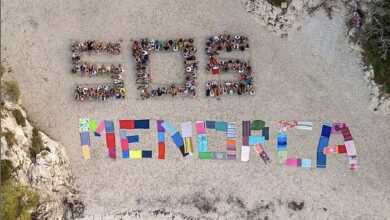 Hundreds of anti-tourism protesters form ‘SOS Menorca’ sign on idyllic beach ‘overrun’ with holidaymakers – after 20,000 people took to the streets in Mallorca