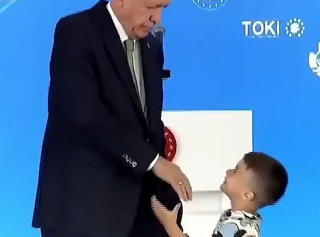 Moment Turkish President Erdogan punches a child in the face for not kissing his hand when he extended it on stage