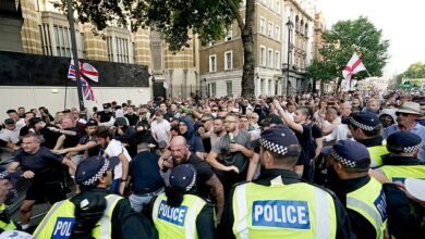 Thugs throw bottles at police and launch flares onto Winston Churchill statue in second night of violence over death of three girls in Southport after ugly riots outside mosque left dozens of officers injured