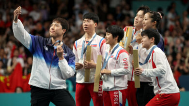 North and South Korean table tennis Olympic medalists pose for shared selfie