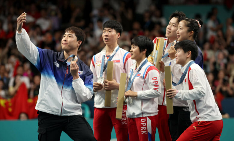 North and South Korean table tennis Olympic medalists pose for shared selfie