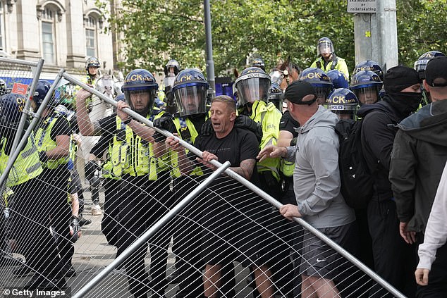 Violence explodes in Manchester as simmering tensions erupt in protests around the UK as riot police guard Belfast while Leeds, Stoke, Liverpool and Hull demos threaten more chaos