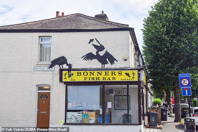 Now it’s Pelican-ksy! Fifth artwork from guerilla artist Banksy in as many days is unveiled as two pelicans eating on the wall of a fish and chip shop after goat, elephants, monkeys and howling wolf from earlier this week