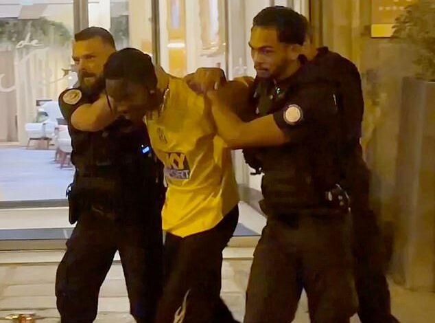 Fresh video shows Travis Scott scuffling with police in five-star Paris hotel and being dragged into a cop car as American rapper remains in French custody