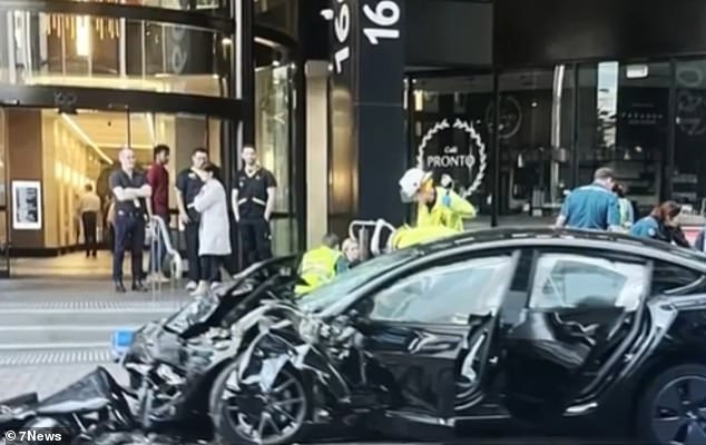 Tesla driver and two paramedics injured after electric car collides with ambulance in Brisbane CBD