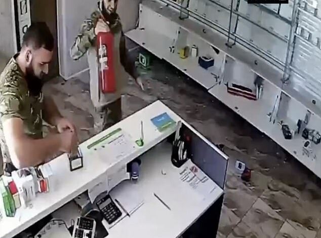 Now Putin’s soldiers are starting to loot their own country: Video shows troops taking advantage of the chaos created by the Kursk invasion of Ukraine to loot a mobile phone shop