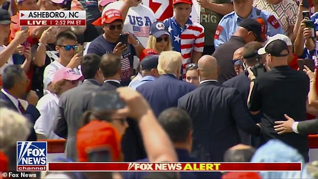 Trump steps outside bulletproof glass to hug woman with medical emergency at first outdoor rally since shooting