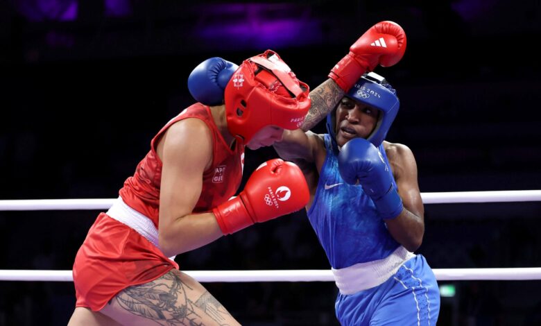 Boxer Ngamba takes first medal for refugee team with quarter-final win