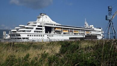 Cruise ship Odyssey FINALLY sets sail, three months after its £27,000-a-month passengers were stranded in Belfast (but still no start date for their three-year round-the-world voyage)