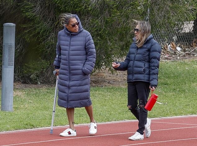 Cathy Freeman is spotted carrying a cane as she makes a rare appearance since announcing her divorce from husband James Murch