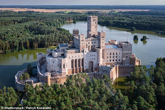 Pictured: The mysterious modern fairytale castle in Poland built on an artificial island in a lake. What is it for? No one seems to know…