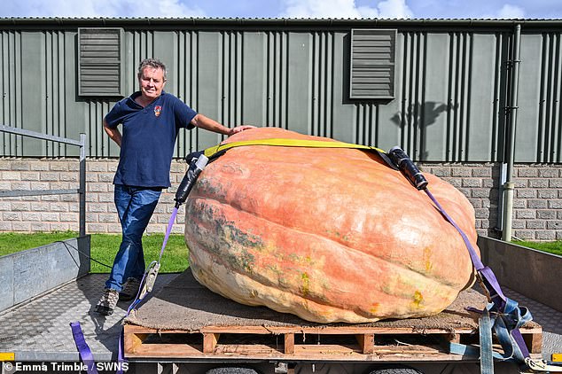 Crushing pumpkin! Twins’ monster veggie weighing 188 stone sets a new British record after they had to use a crane to get it to the country show