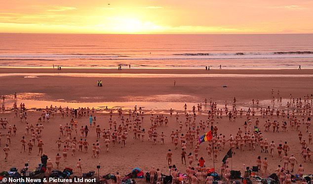 Waking up naked! 1,200 brave skinny dippers run into the icy North Sea for charity