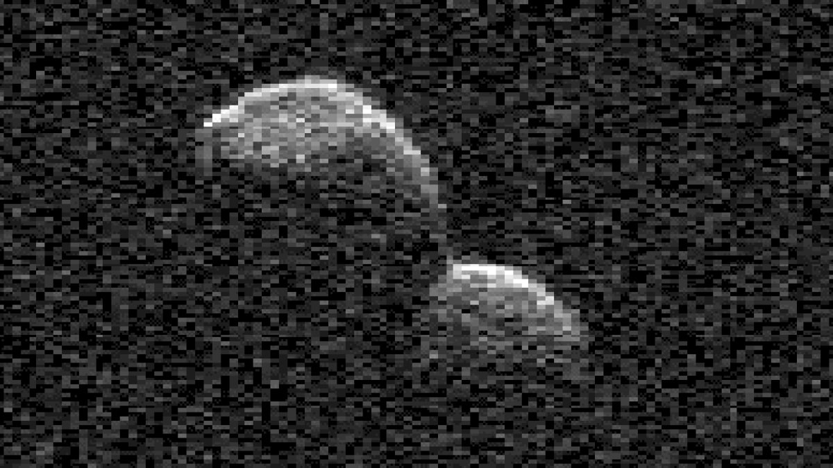 A snowman-shaped asteroid tumbles past Earth at incredible speed