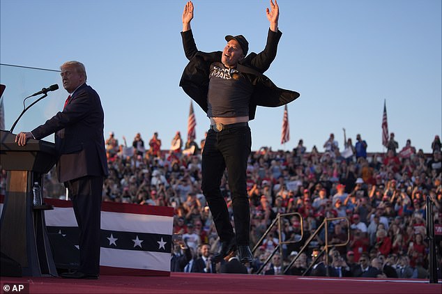 Excited Elon Musk JUMPS onstage to join Trump in Butler as he reenacts the former president’s ‘fight, fight, fight’ moment after he was shot