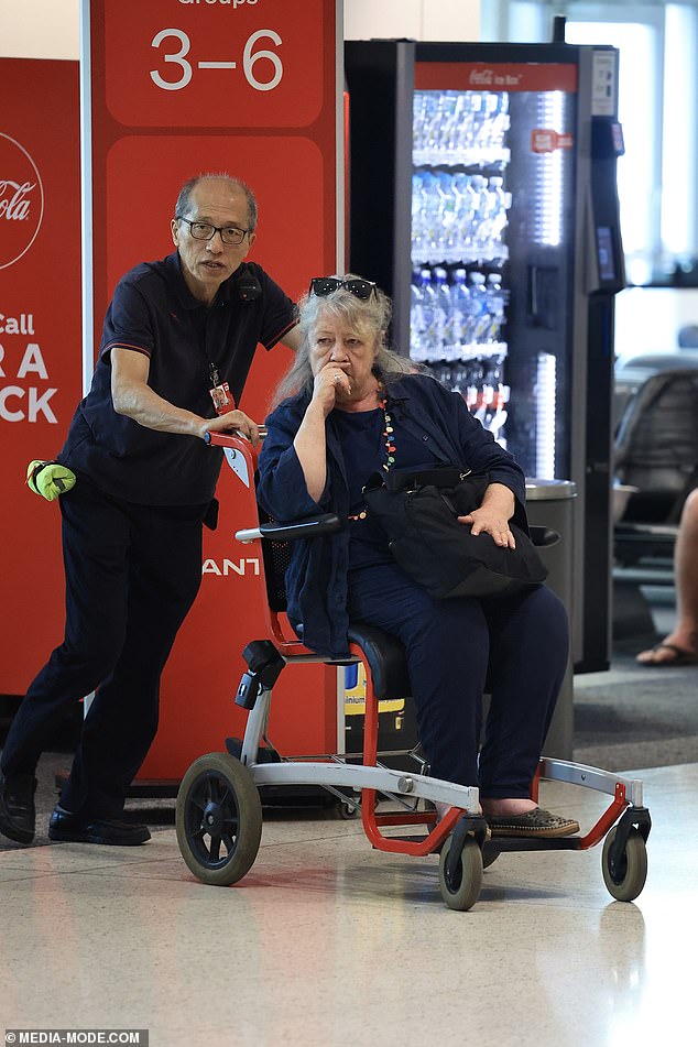 Australian actress Noni Hazlehurst, 71, is gently pushed through Sydney Airport in a wheelchair after disembarking from a plane