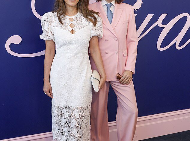 Elizabeth Hurley cuts an elegant figure in a white lace gown as she joins her lookalike son Damian at Crown Oaks Day – but will she catch up with Shane Warne’s kids?