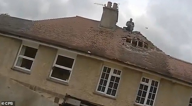 Moment man climbed onto roof and threw tiles at neighbors ‘as he ‘systematically destroyed’ two houses during a seven-year fight over a fence’