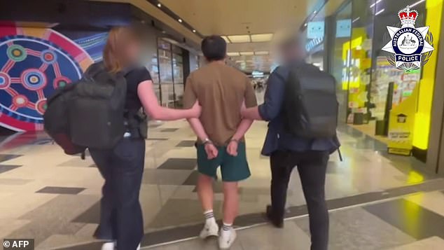 Dramatic moment as officers march a man through Sydney Airport after he was caught trying to deposit  million in dirty money into a Brisbane bank