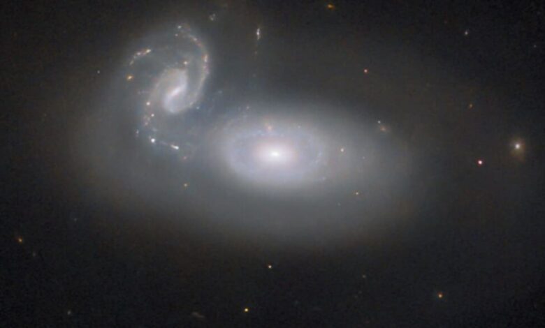 Hubble shows cosmic collisions of two galaxies in the Coma Cluster.