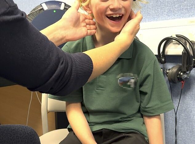 Watch the joyful moment when a boy born deaf in one ear receives a new hearing aid