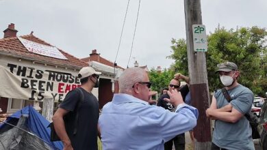 Watch the moment a boomer loses out with a group of anti-landlord protesters occupying an upscale Melbourne suburb – before being led away by police